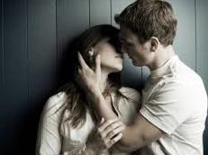 man touching woman's neck